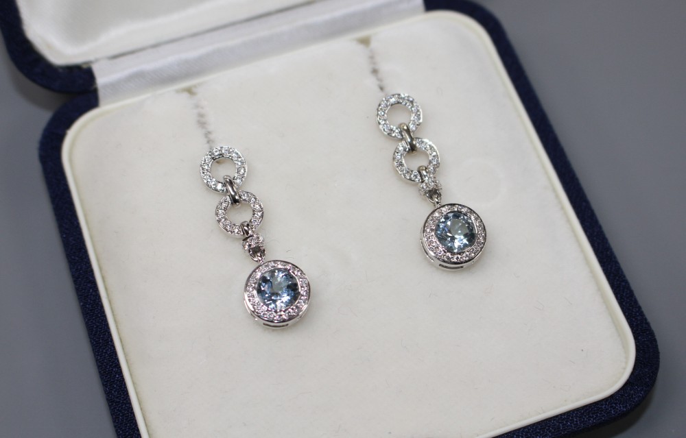 A modern pair of 18ct white gold, aquamarine and diamond set drop earrings, drop 29mm, gross weight 7.5 grams.